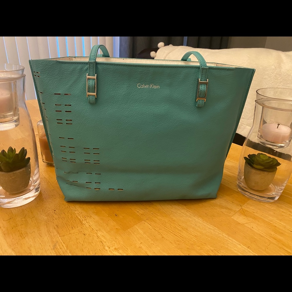 Teal Calvin Klein Tote w/ flaws from wear clearly show.